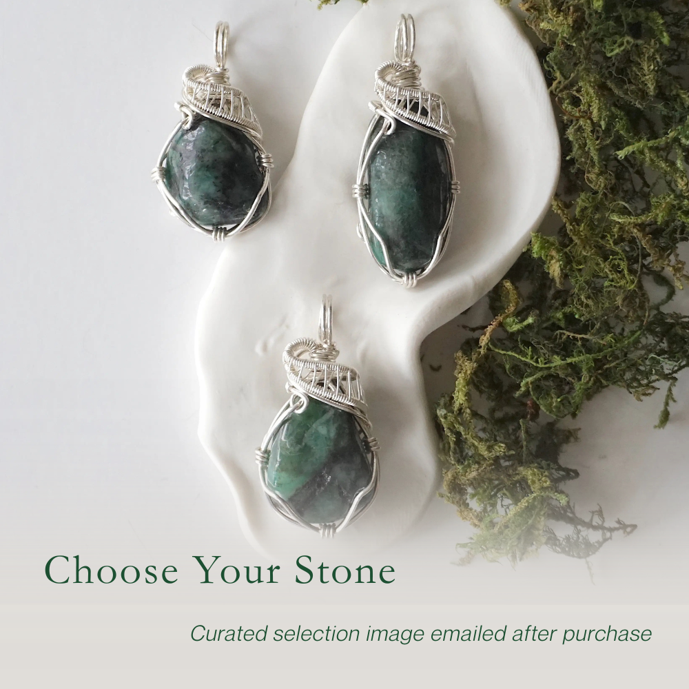 Three polished raw emerald pendants for women showing natural variation in emerald size, shape, and green colour in sterling silver wire wrapping