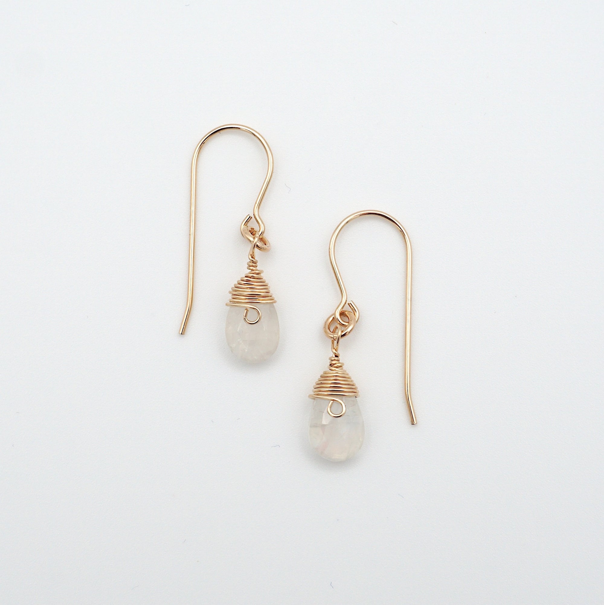 Angled look at rainbow moonstone drop earrings, artisan wire wrapping in 14k gold filled, June birthstone
