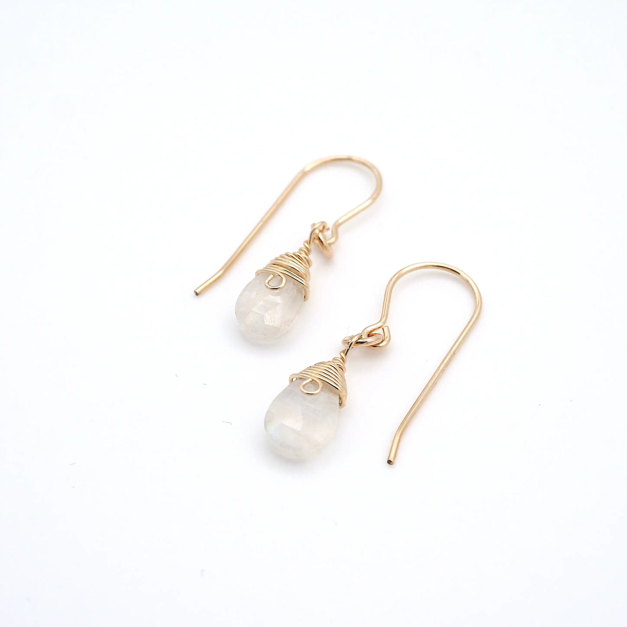 Closeup showing details of rainbow moonstone drop earrings, faceted rainbow moonstone stone, 14k gold filled setting
