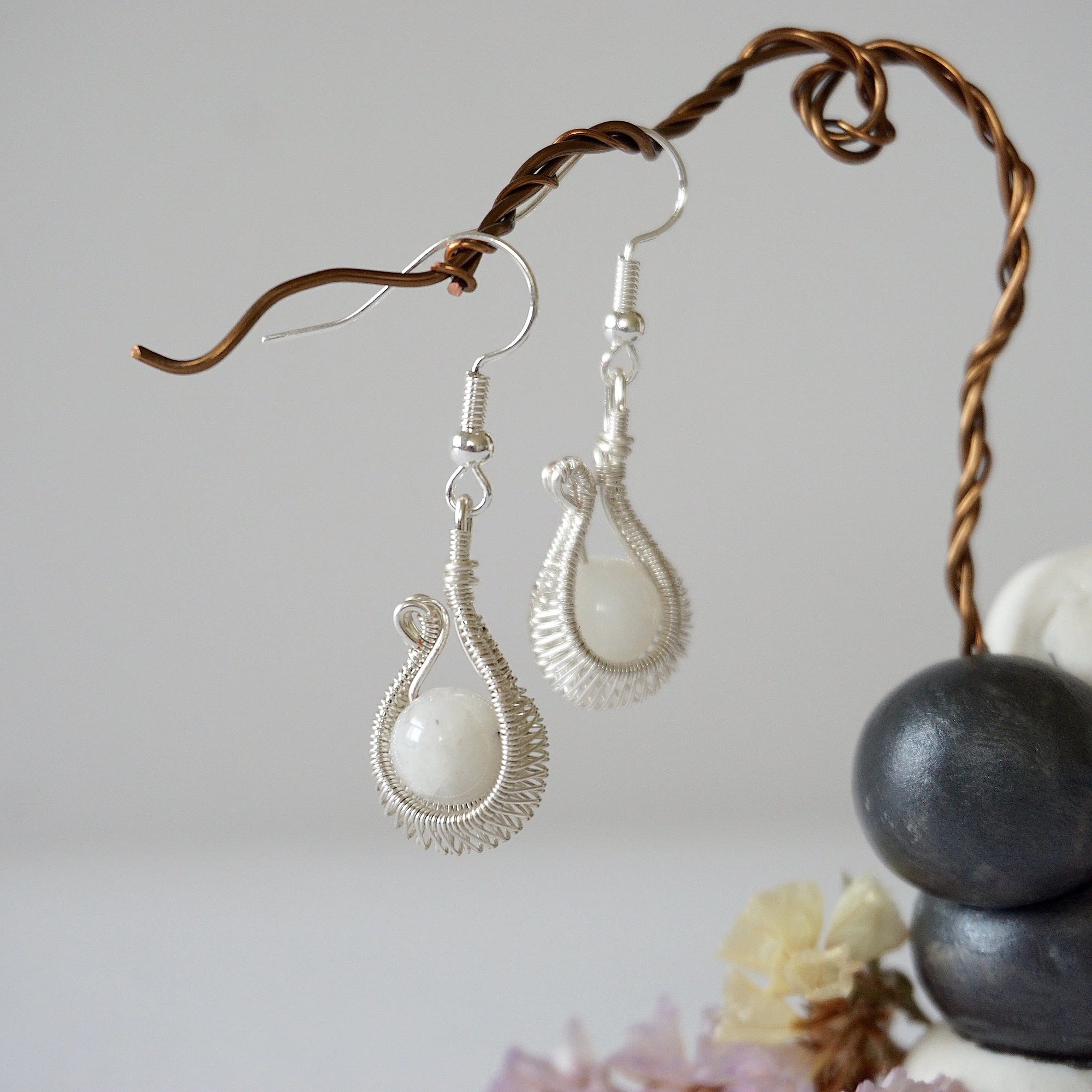 Close-up of rainbow moonstone drop earrings with natural 8mm moonstone beads in intricate soft silver wire wrap, June birthstone dangle earrings.