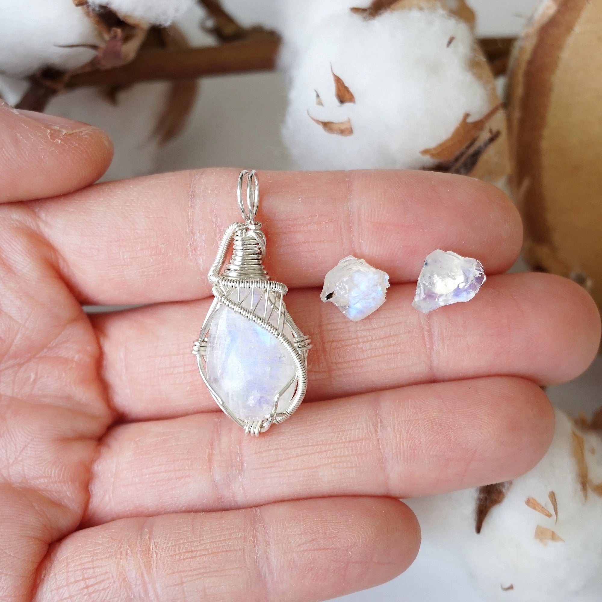 Rainbow moonstone necklace and stud earrings set in hand for size reference, sterling silver pendant and raw moonstone studs (June birthstone).