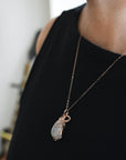 Model wearing rainbow moonstone necklace with 14k rose gold filled chain and handmade cabochon pendant
