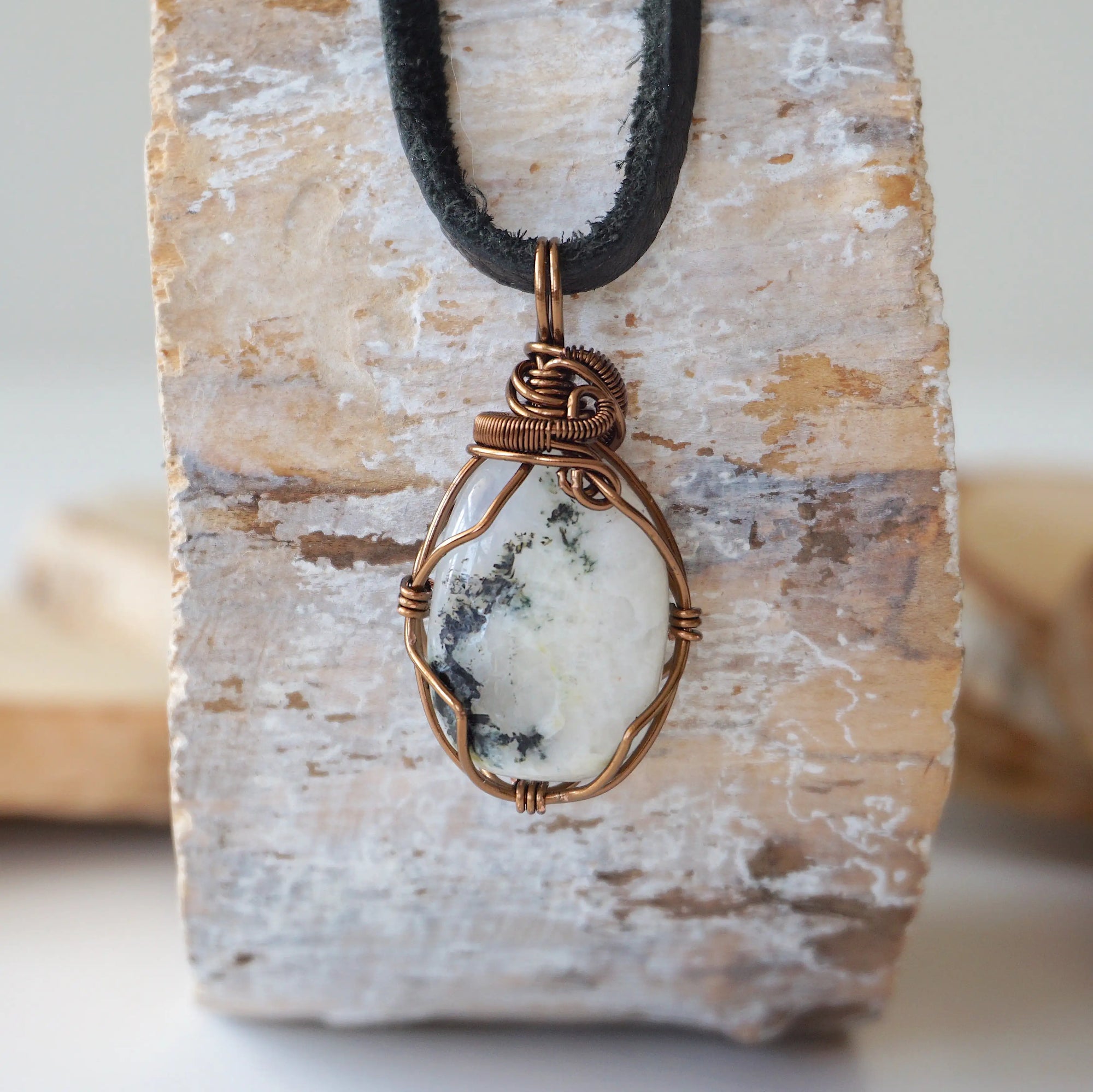 Back view of rainbow moonstone pendant necklace showing secure handcrafted antique bronze copper wire wrapping