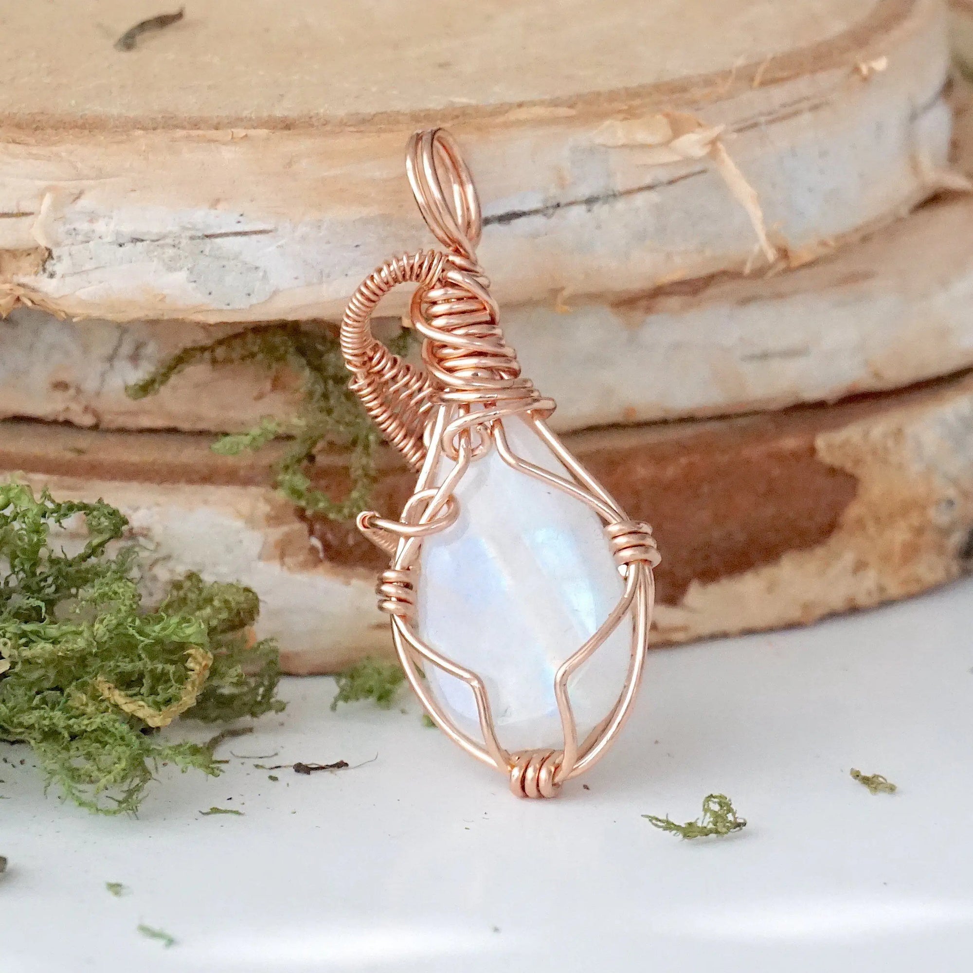 Back view of rainbow moonstone cabochon pendant showing secure handcrafted 14k rose gold filled wire wrapping