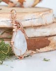 Right angle view of rainbow moonstone pendant showing detailed artisan 14k rose gold filled wire wrapping