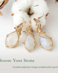 Three rainbow moonstone pendants showing natural variation in size and flash in handmade artisan jewelry