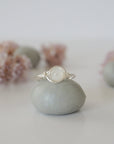 Front close-up of minimalist rainbow moonstone bead ring in sterling silver wire wrap, June birthstone ring for women.