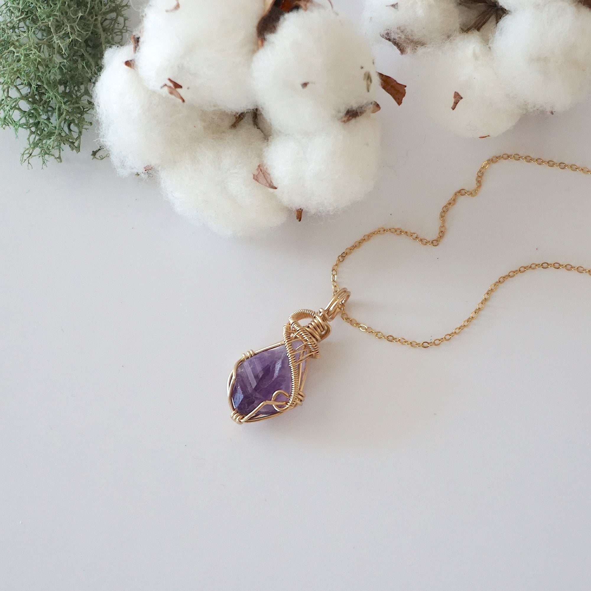 Raw amethyst necklace in 14k gold filled laying flat. Handcrafted February birthstone jewelry for women by Designs by Nature Gems.