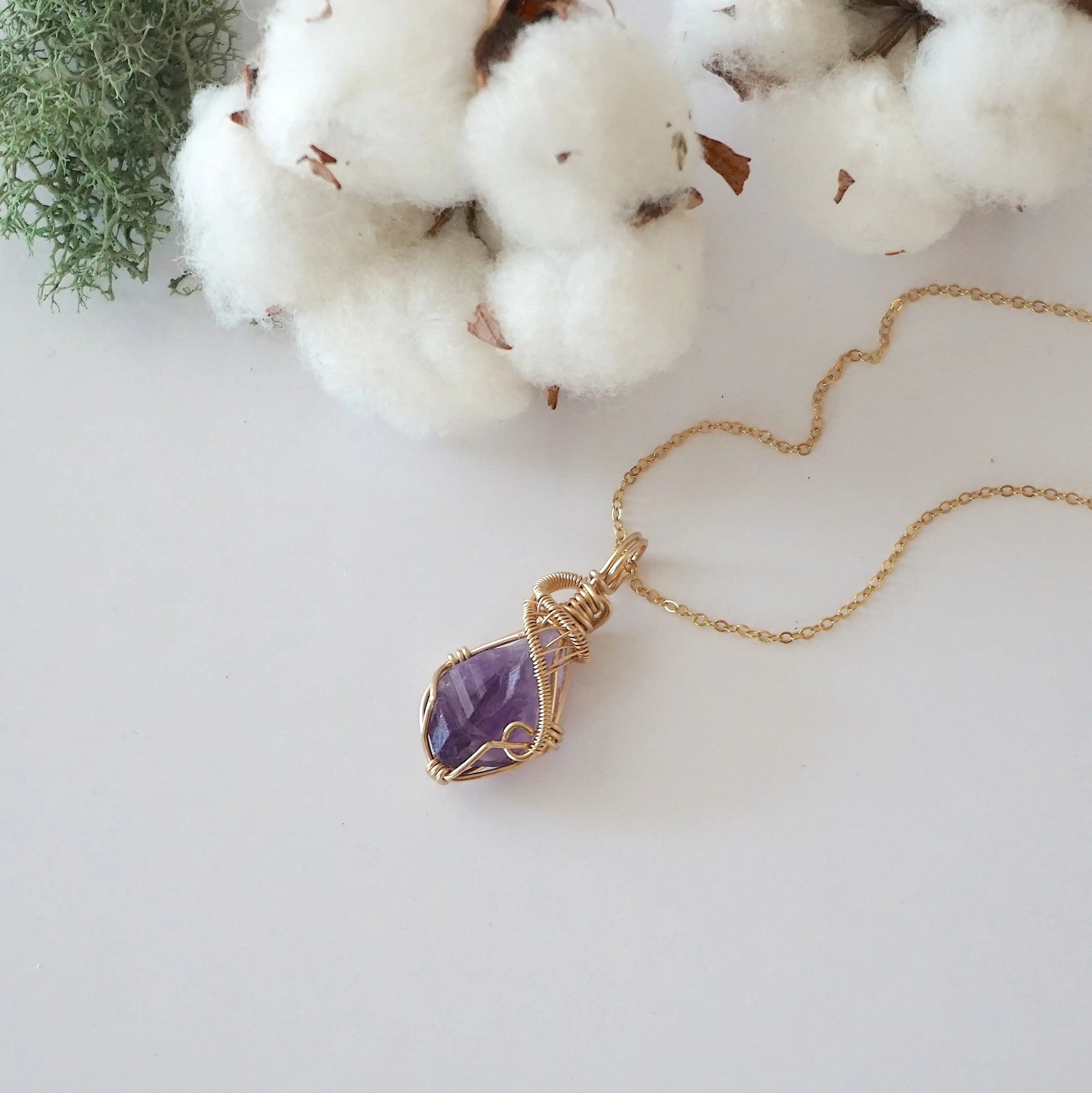 Raw amethyst necklace in 14k gold filled laying flat. Handcrafted February birthstone jewelry for women by Designs by Nature Gems.