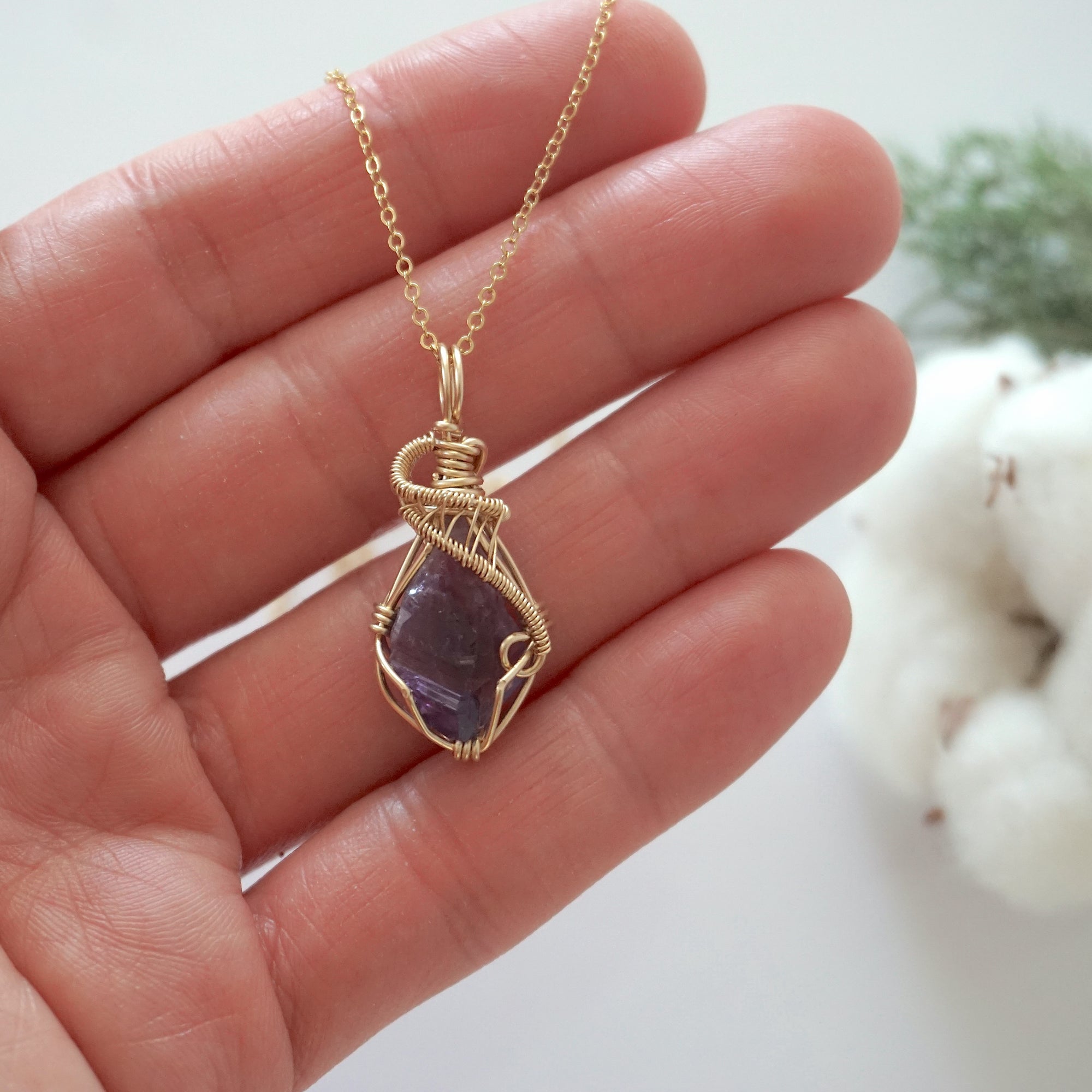Raw amethyst necklace in 14k gold filled shown in hand for size reference. Artisan February birthstone pendant by Designs by Nature Gems.