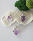 Three raw amethyst necklaces showing natural purple crystal variations in handmade wire wrapped pendants
