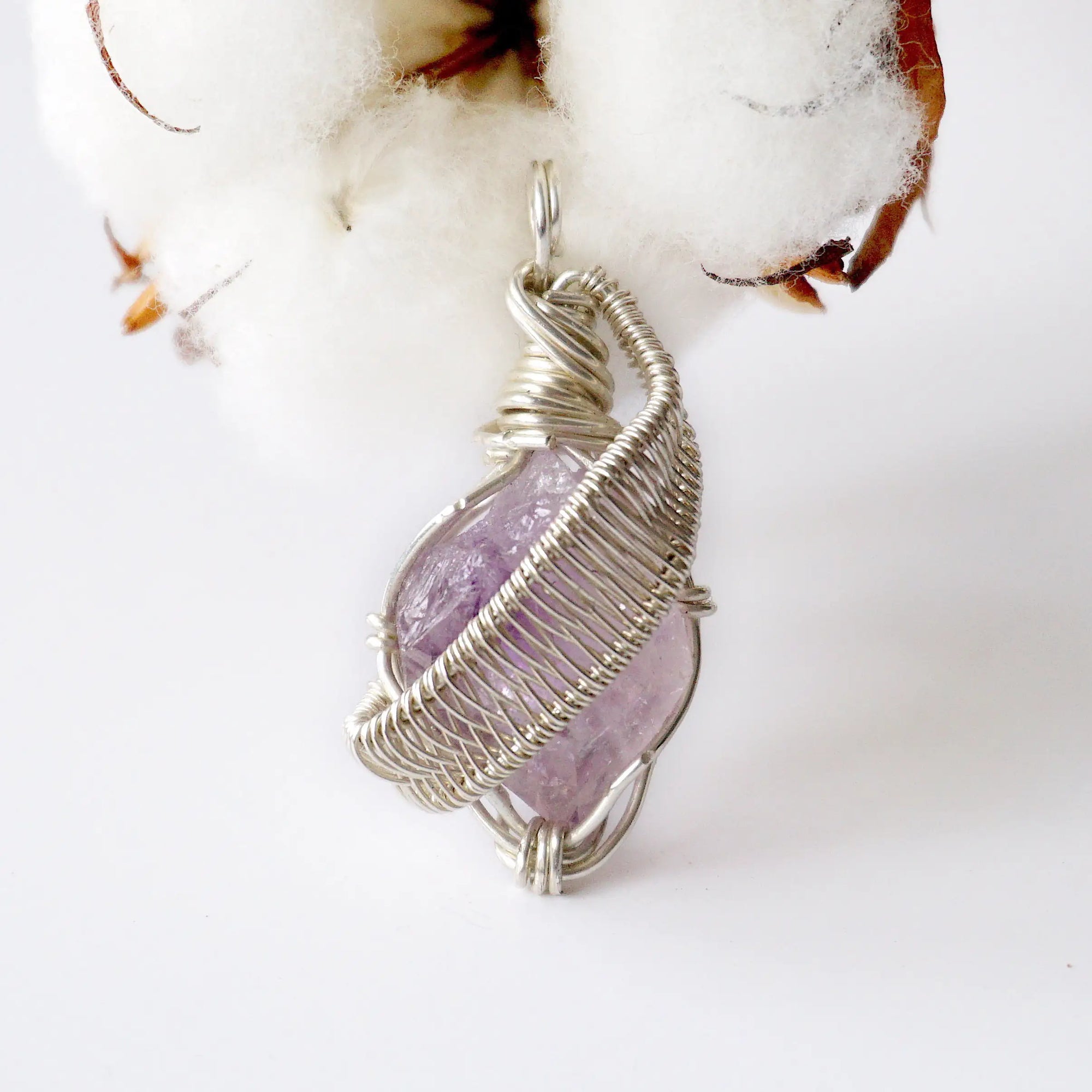 Detailed front view of raw amethyst pendant, natural amethyst crystal wrapped in sterling silver artisan wire
