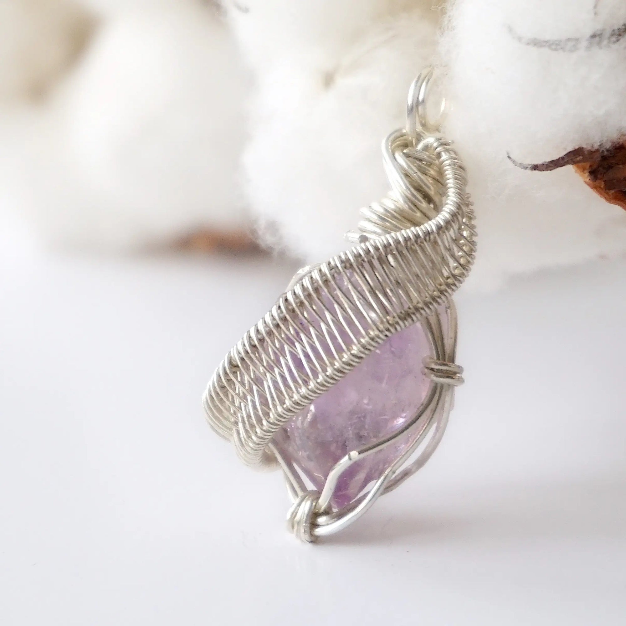 Left side angle of raw amethyst pendant, natural amethyst crystal, sterling silver artisan wire wrap
