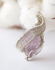 Left side angle of raw amethyst pendant, natural amethyst crystal, sterling silver artisan wire wrap