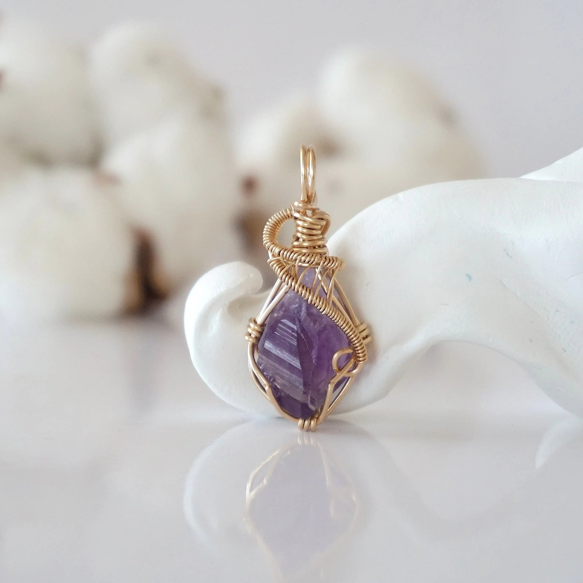 Detailed front view of raw amethyst pendant in 14k gold filled. Unique wire wrapped February birthstone jewelry by Designs by Nature Gems.