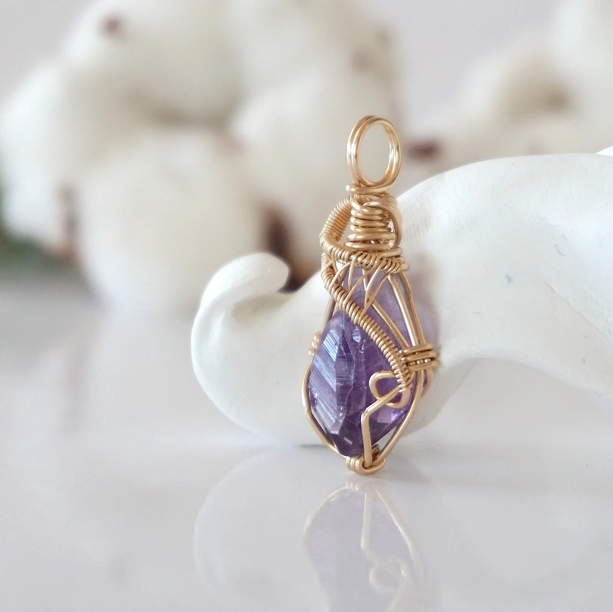 Side view of raw amethyst pendant in 14k gold filled, showing artisan wire wrapping. Handcrafted February birthstone necklace by Designs by Nature Gems.