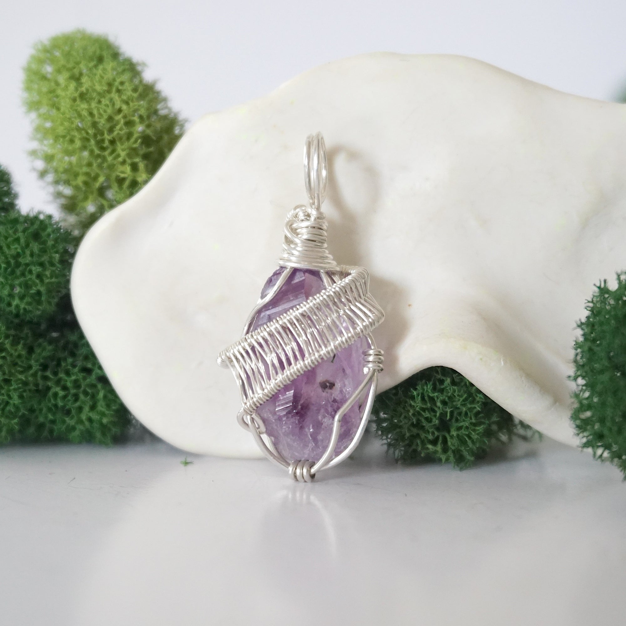 Back view of raw amethyst necklace pendant with handcrafted sterling silver wire work