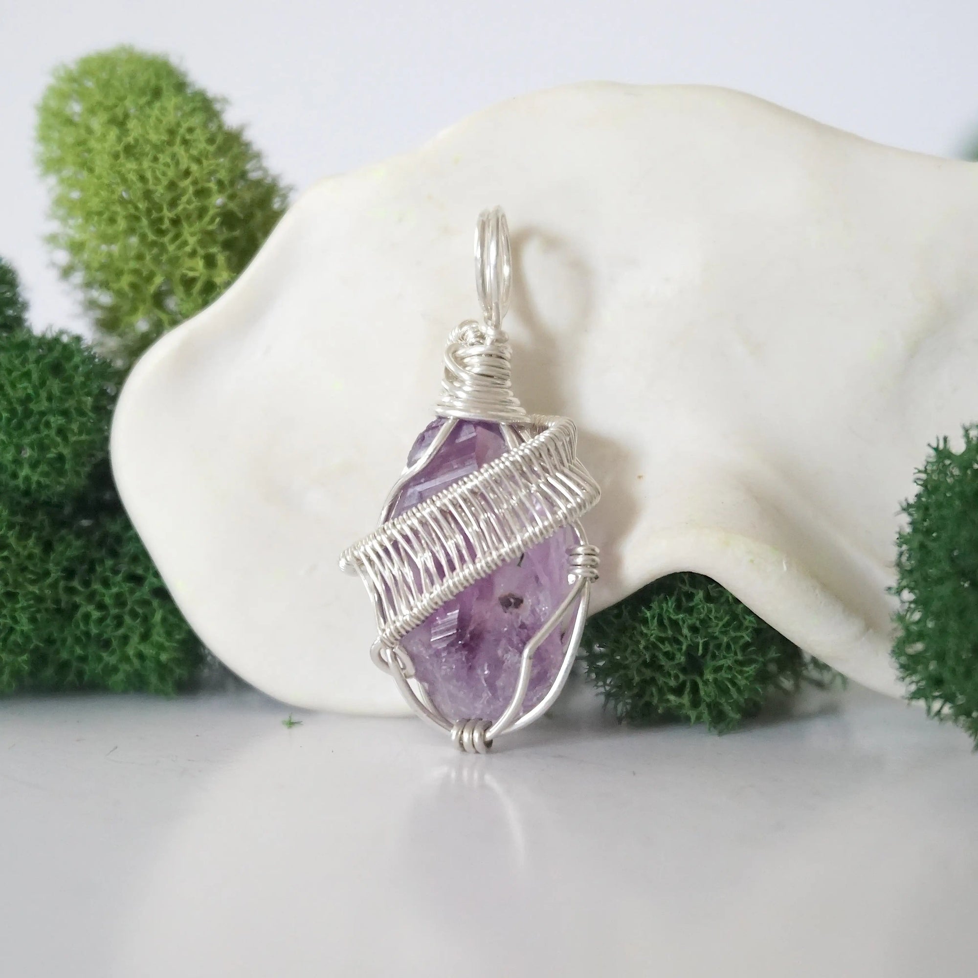 Back view of raw amethyst necklace pendant with handcrafted sterling silver wire work