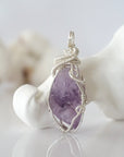 Front view of raw amethyst pendant — natural unpolished lavender amethyst stone hand-wrapped in detailed 925 sterling silver wire, handcrafted artisan jewelry