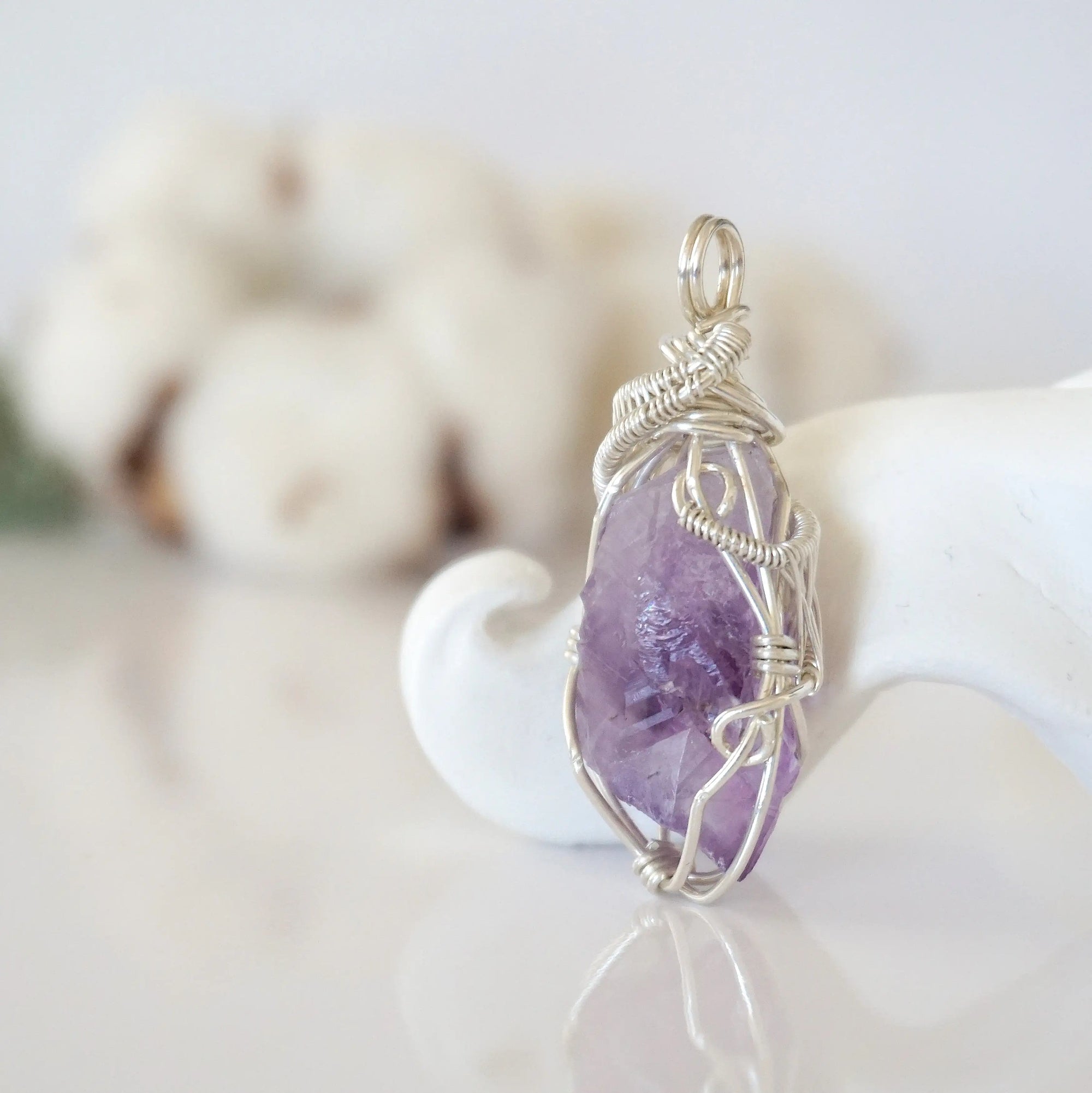 Right side detail of raw amethyst crystal pendant — intricate 925 sterling silver wire weaving technique, handcrafted artisan wire wrapped jewelry, Designs by Nature Gems