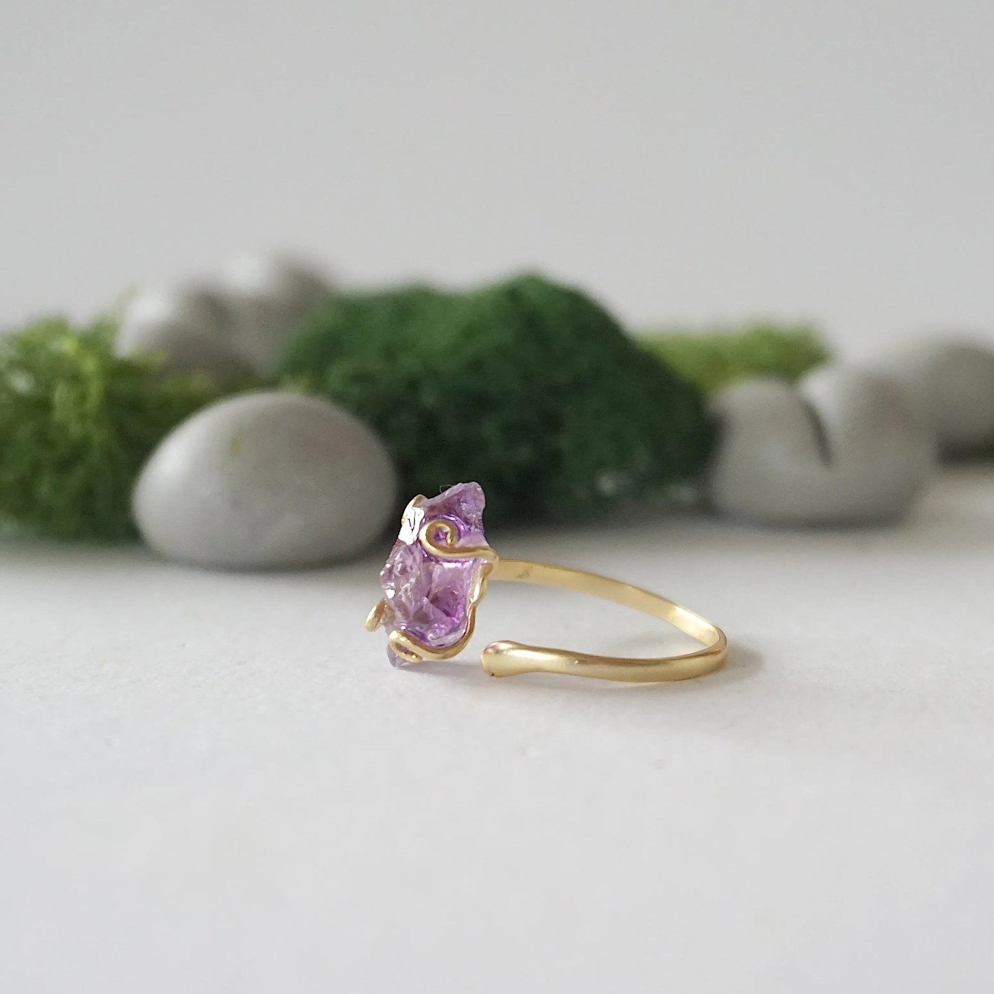 Left side detail of raw amethyst crystal ring in 14k gold vermeil claw setting, adjustable women’s ring