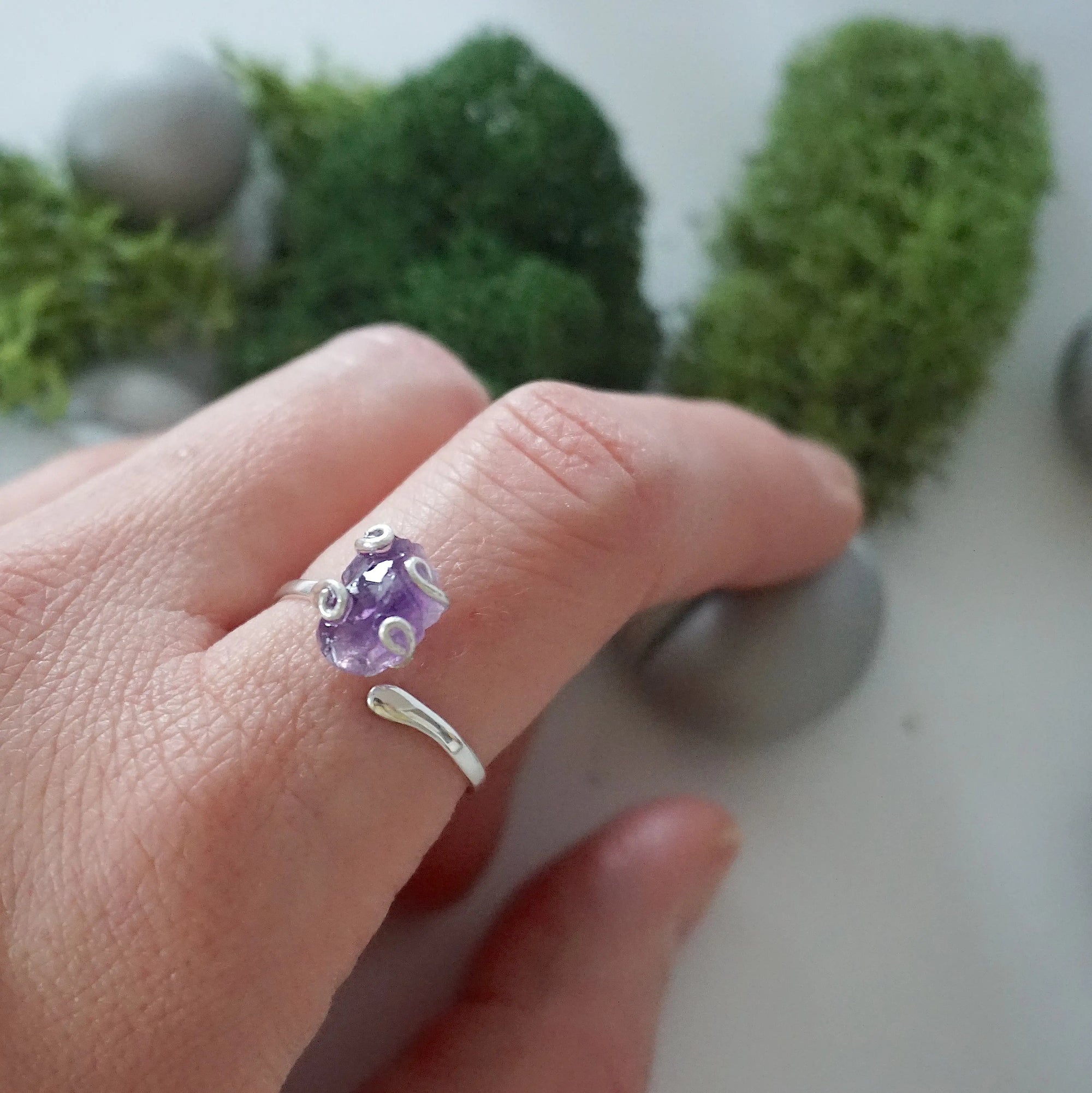 Raw amethyst ring for women in sterling silver claw setting, adjustable band on model hand