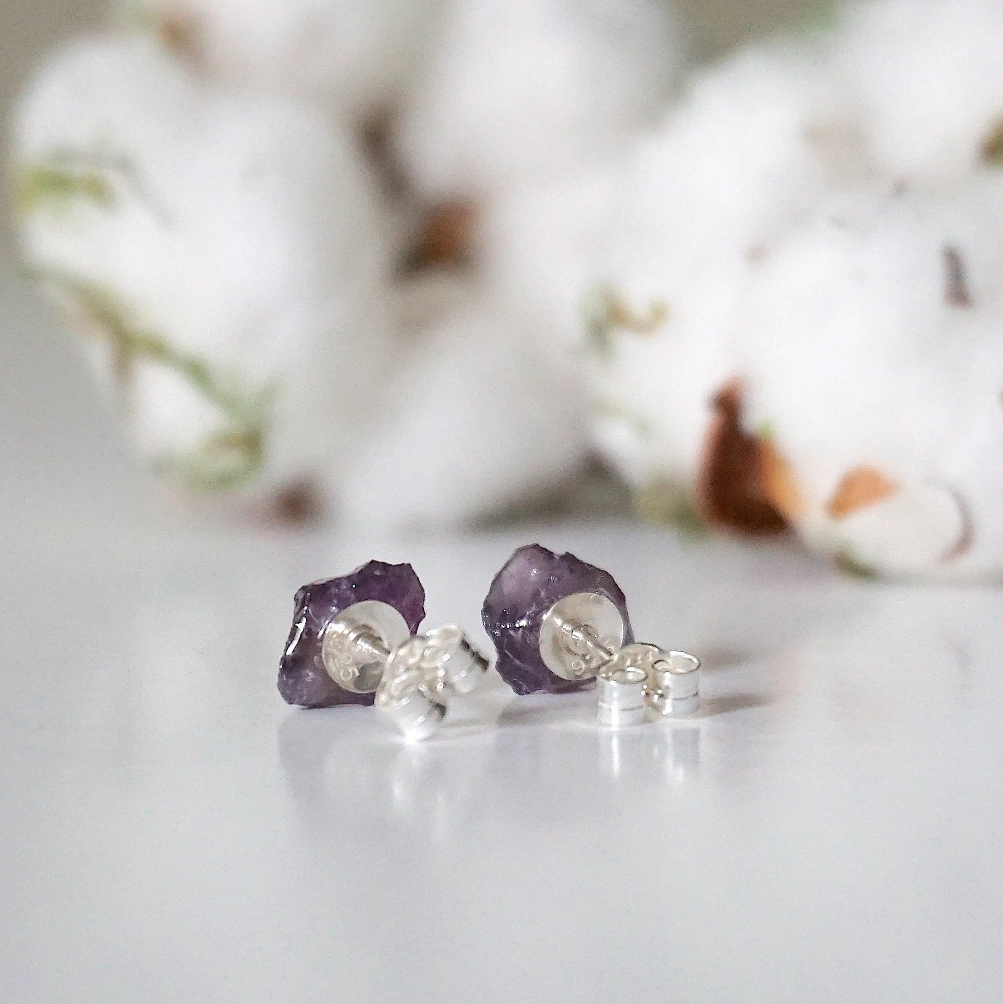 Back view of raw amethyst stud earrings, unpolished natural amethyst stones and sterling silver posts
