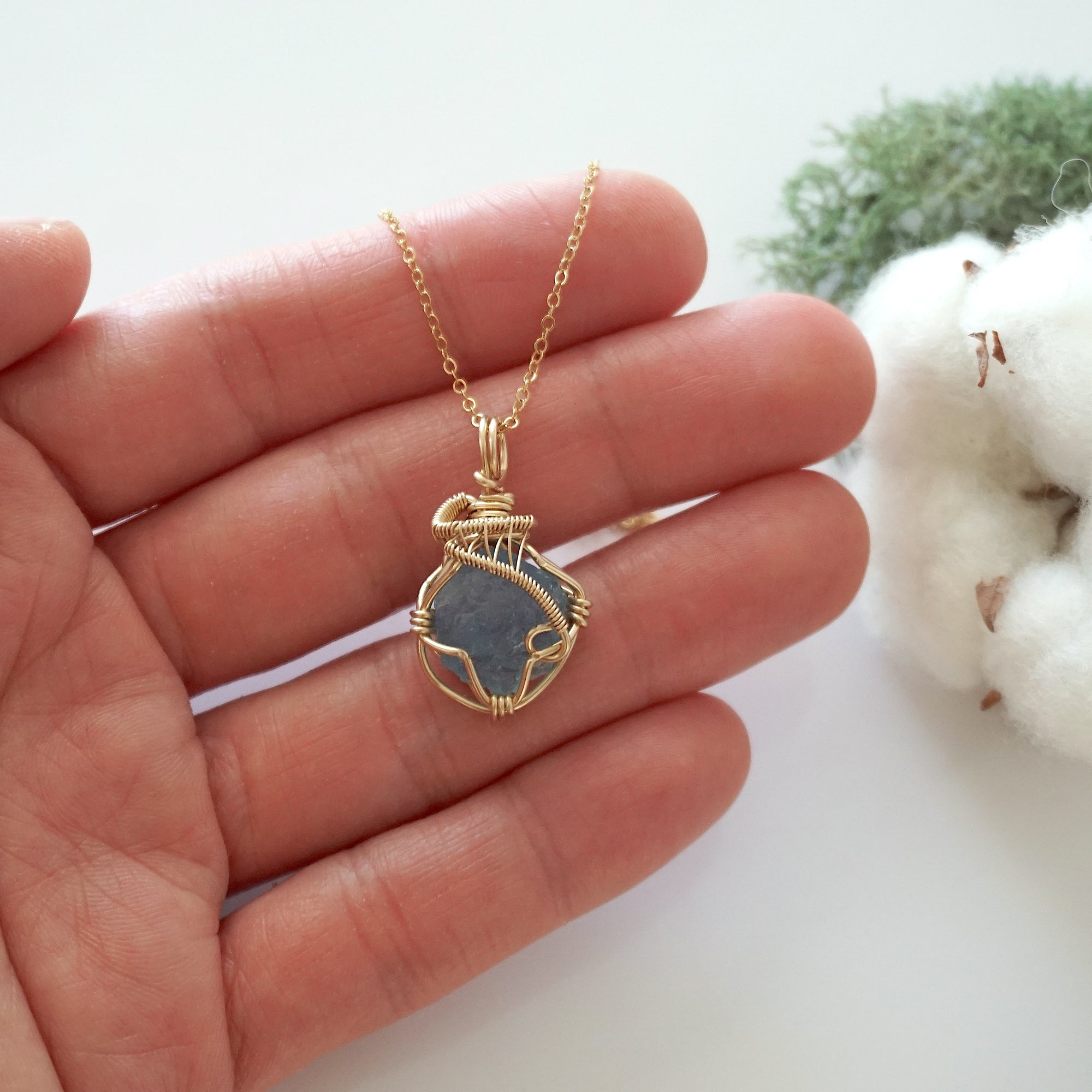 Raw aquamarine necklace in 14k gold filled shown in hand for size reference. Artisan March birthstone pendant by Designs by Nature Gems.