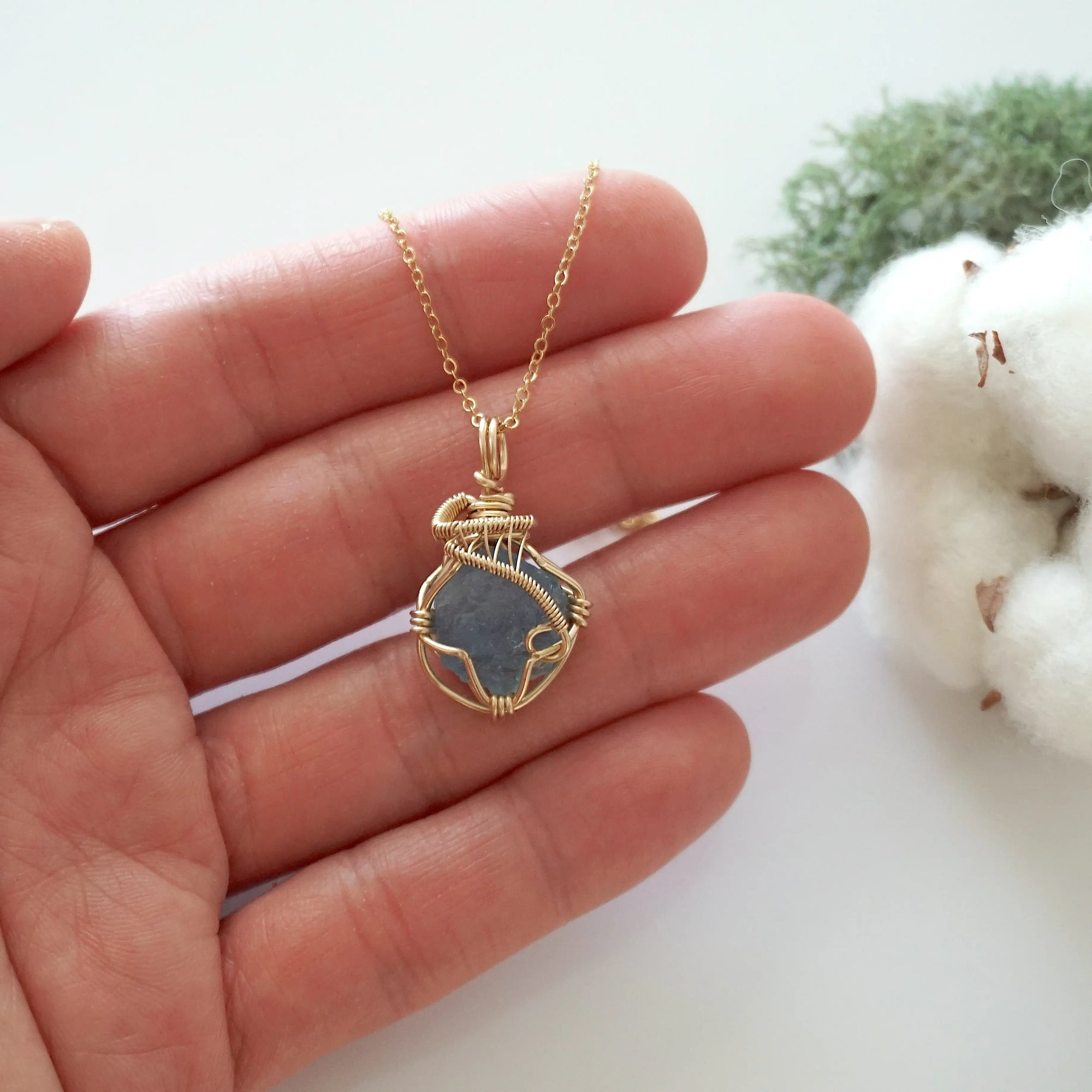 Raw aquamarine necklace in 14k gold filled shown in hand for size reference. Artisan March birthstone pendant by Designs by Nature Gems.
