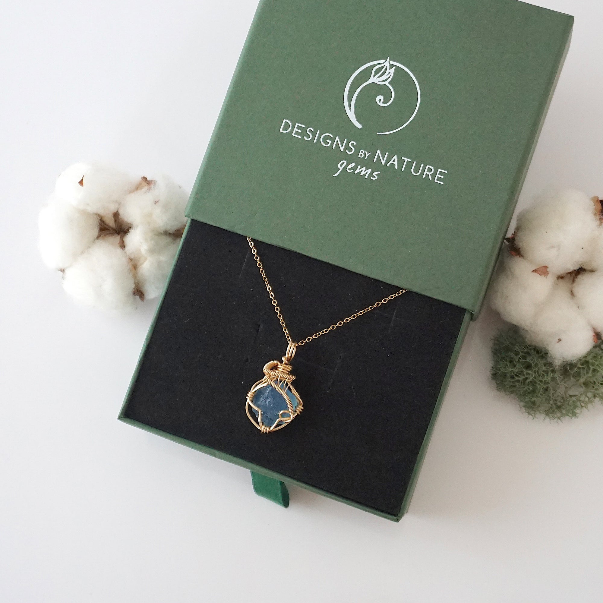 Raw aquamarine necklace in 14k gold filled displayed in branded Designs by Nature Gems jewelry box. Artisan March birthstone gift for women.