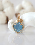 Back view of raw aquamarine pendant in 14k gold filled, highlighting stone and wire detail. One of a kind March birthstone jewelry by Designs by Nature Gems.