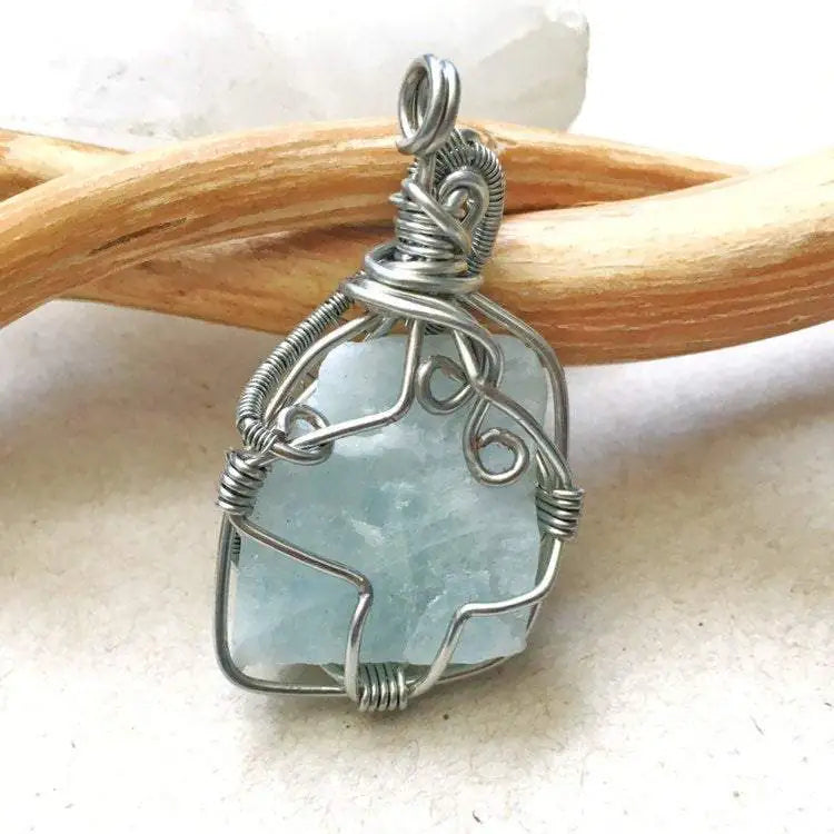 Back view of raw aquamarine pendant, genuine stone with handcrafted dark silver wire