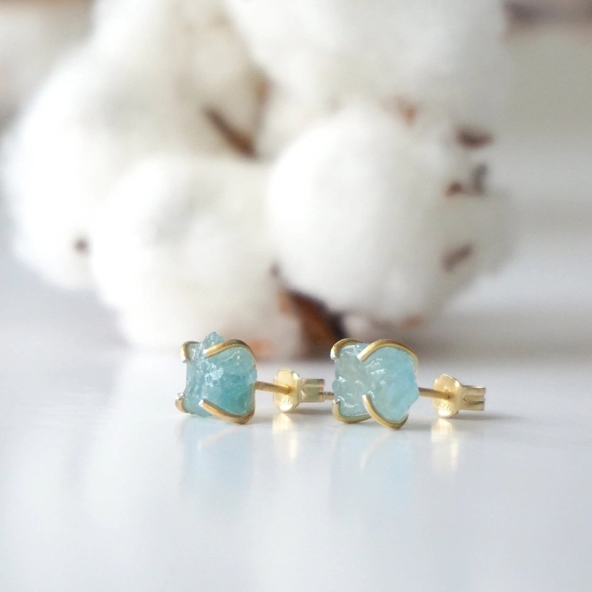 Left side angle of raw aquamarine stud earrings, genuine gemstone in 14k gold vermeil, Designs by Nature Gems