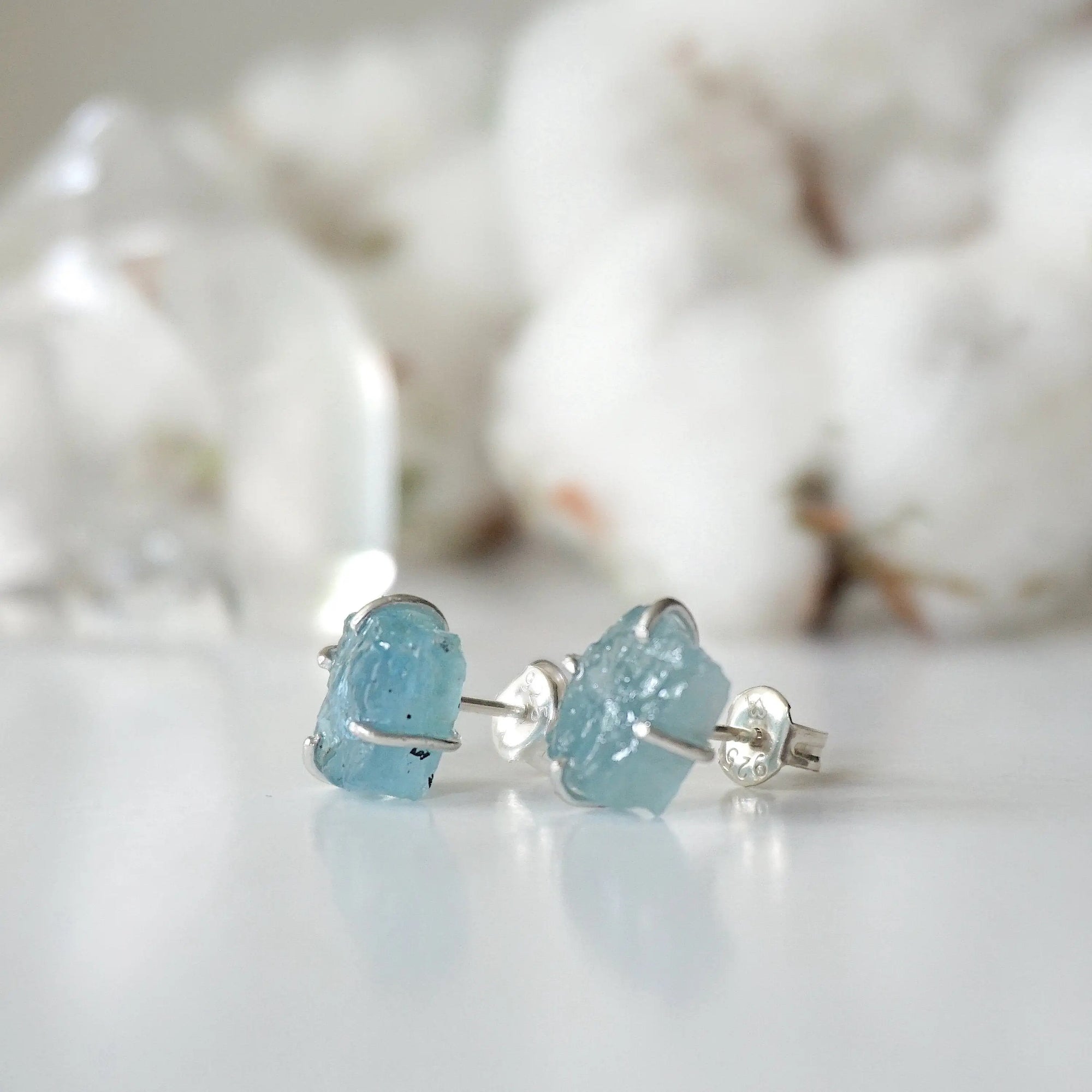 Left side angle of raw aquamarine stud earrings, genuine gemstone in 925 sterling silver, Designs by Nature Gems