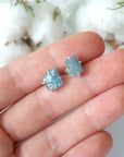 Raw aquamarine stud earrings shown in hand for size reference. Artisan March birthstone earrings by Designs by Nature Gems