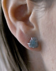 Raw aquamarine earrings in sterling silver on a female model. Handcrafted March birthstone jewelry for women by Designs by Nature Gems
