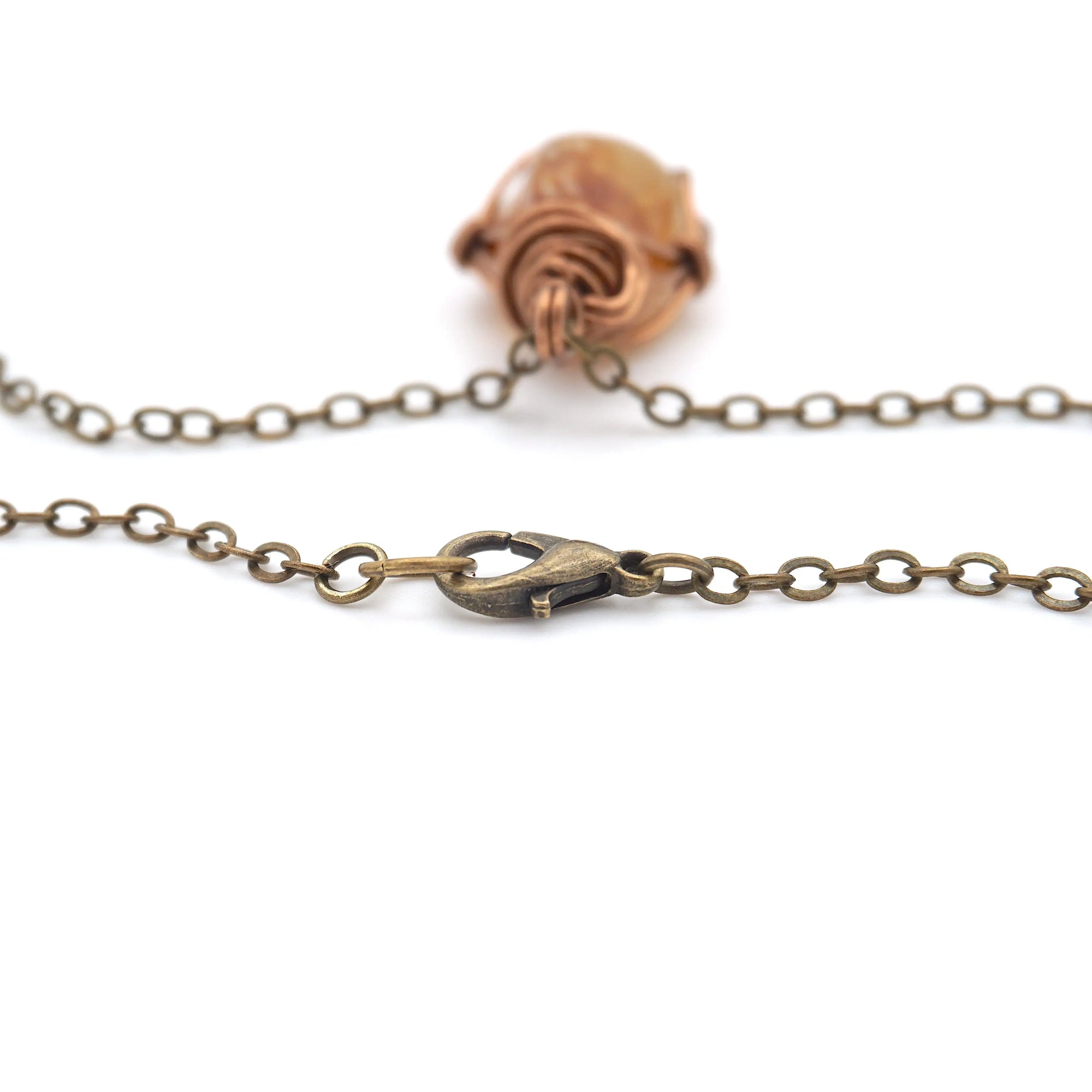 Close-up of a bronze chain with a clasp on a white background