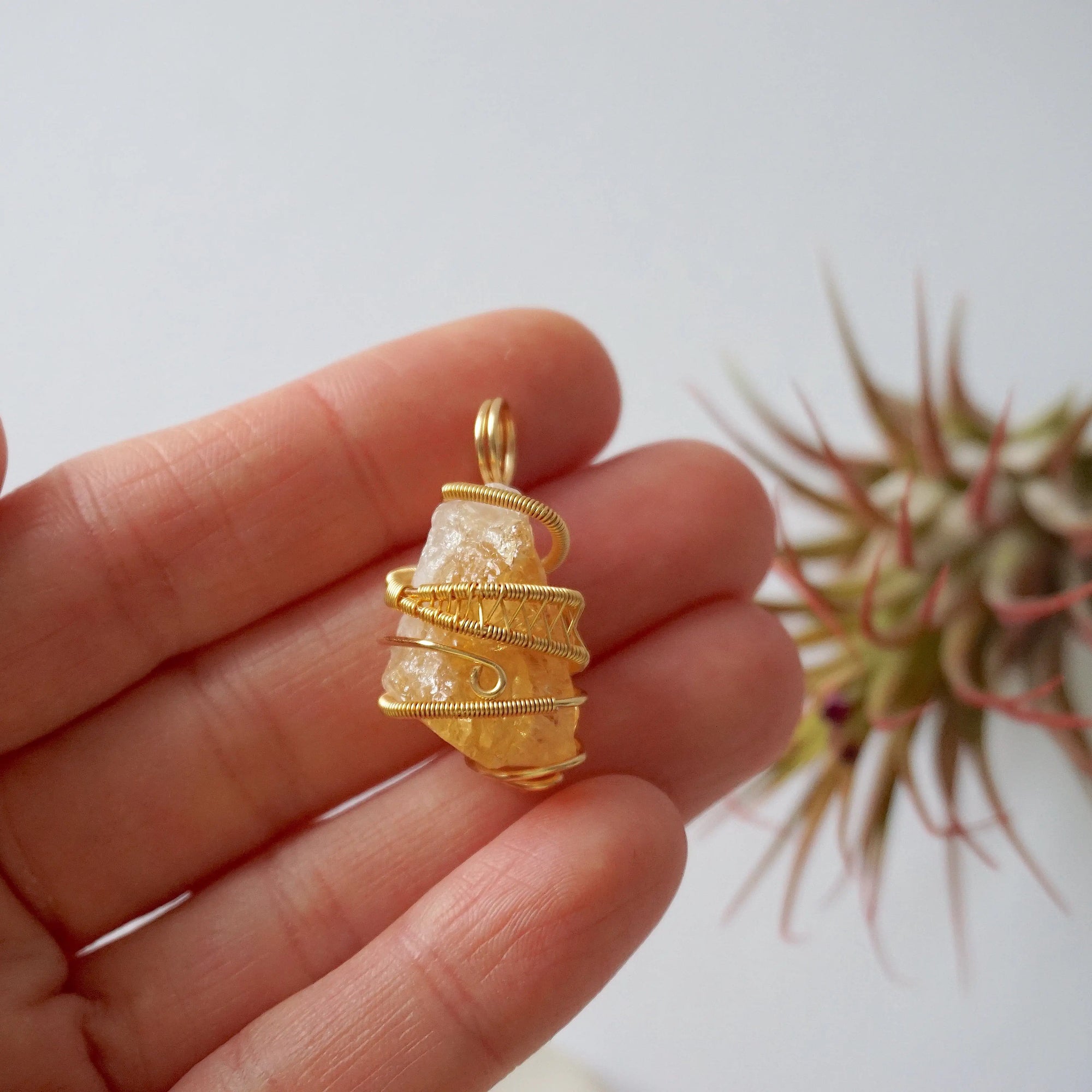 Raw citrine pendant held in hand showing size scale - natural unpolished crystal wire wrapped in gold plated copper handmade necklace size reference