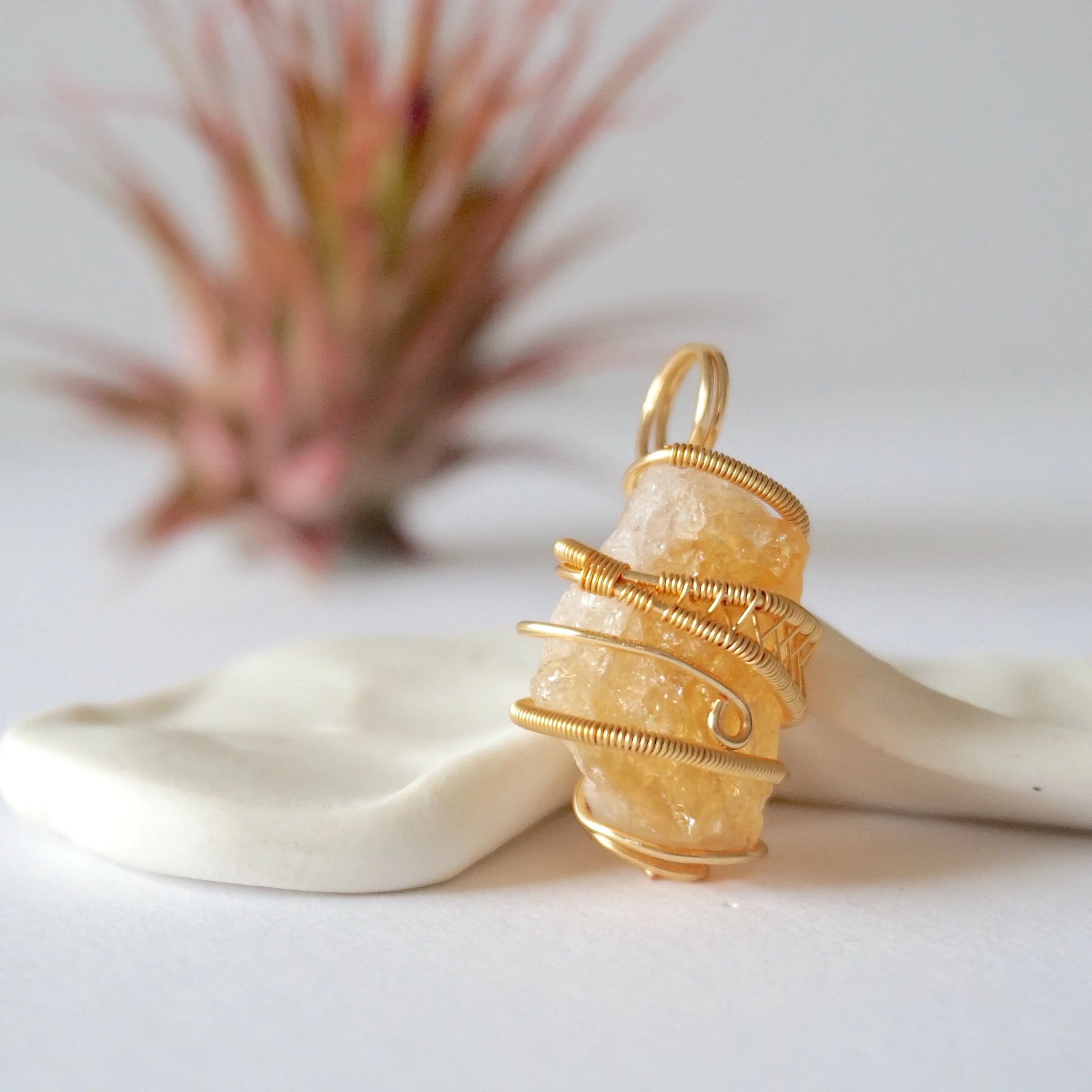 Side angle view of raw citrine pendant showing crystal dimension and wire wrapping detail - natural unpolished stone in gold plated copper handmade jewelry