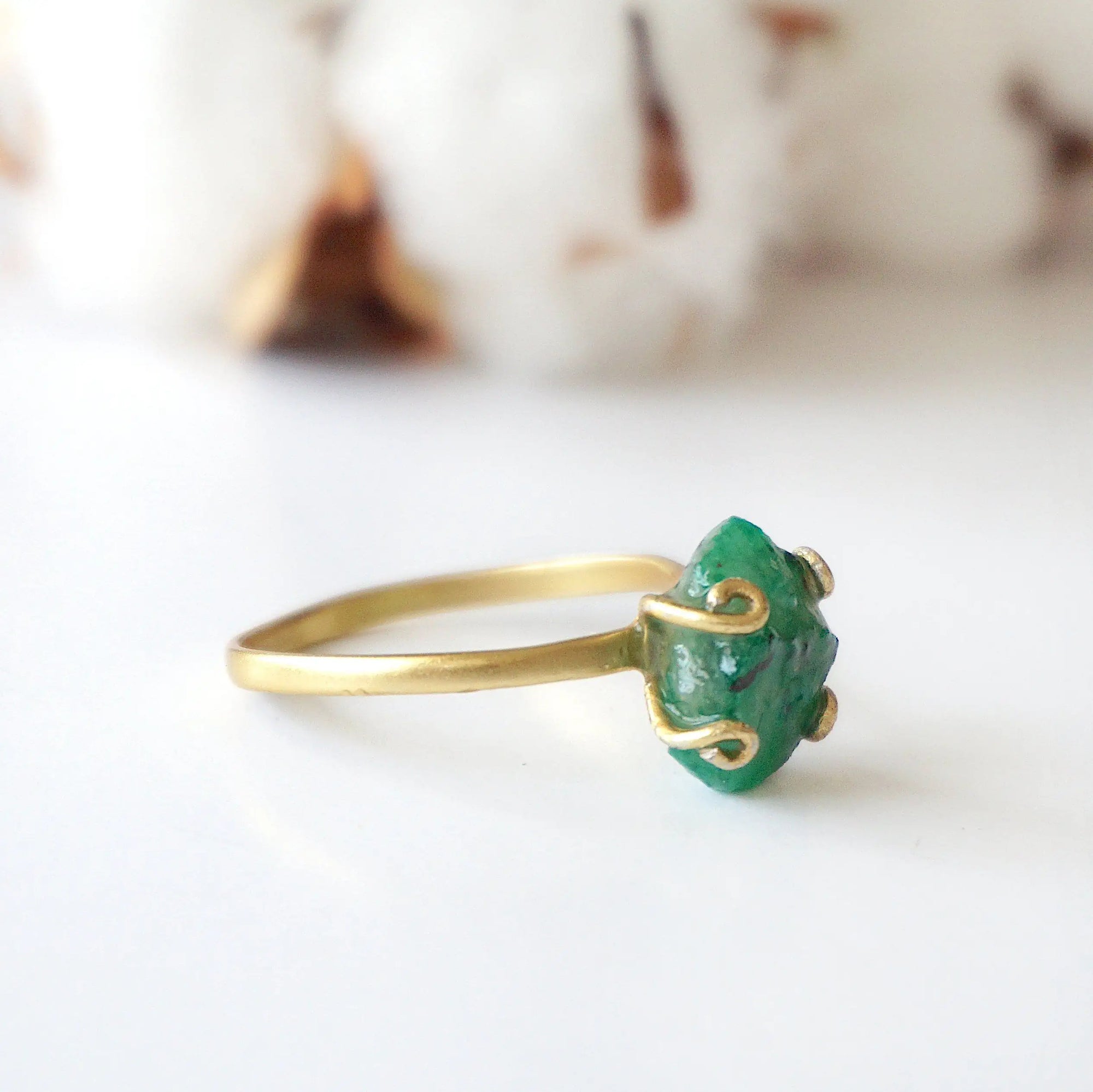 Left side view of raw emerald ring in gold vermeil with adjustable band and handcrafted artisan details