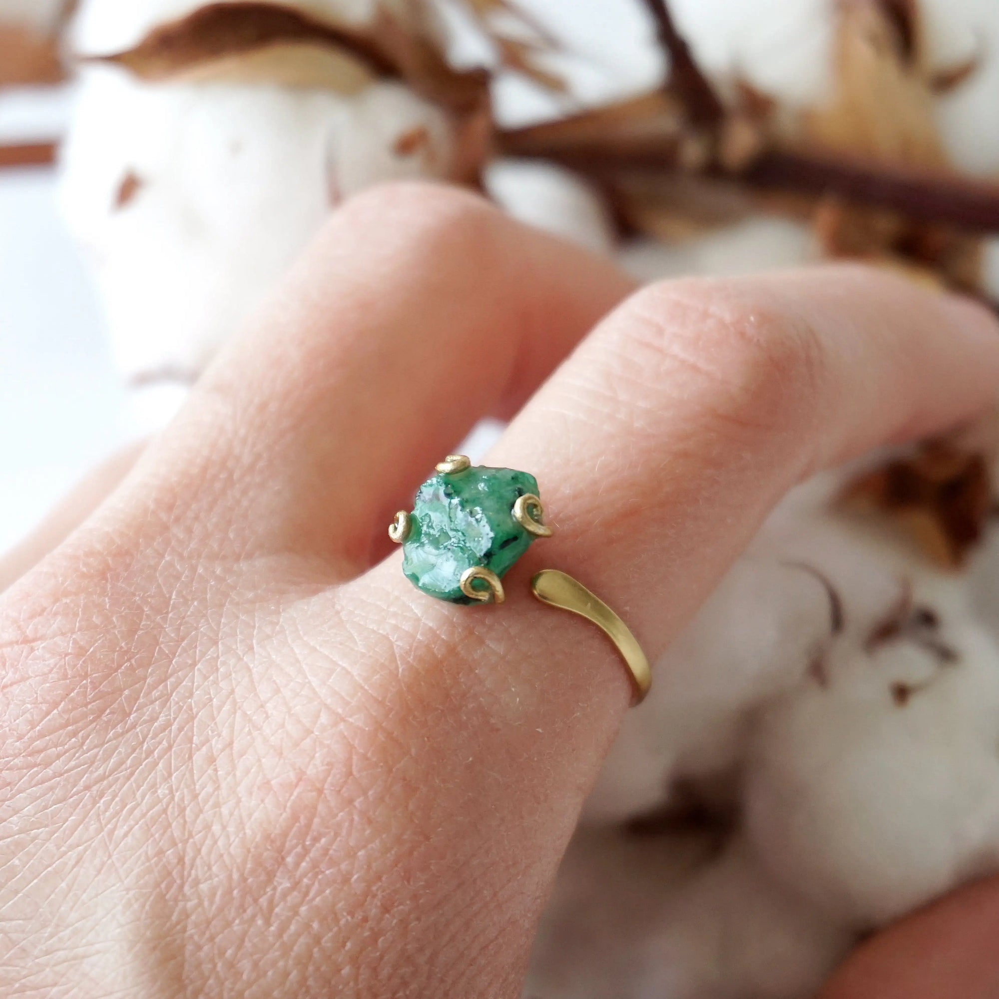 Raw emerald adjustable ring in gold vermeil worn on a woman's hand, natural May birthstone ring for women