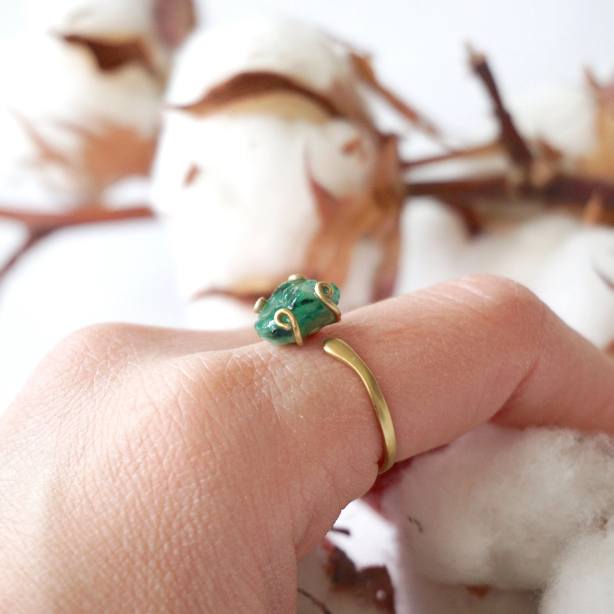 Natural raw emerald ring in gold vermeil on female hand, adjustable artisan gemstone ring for women