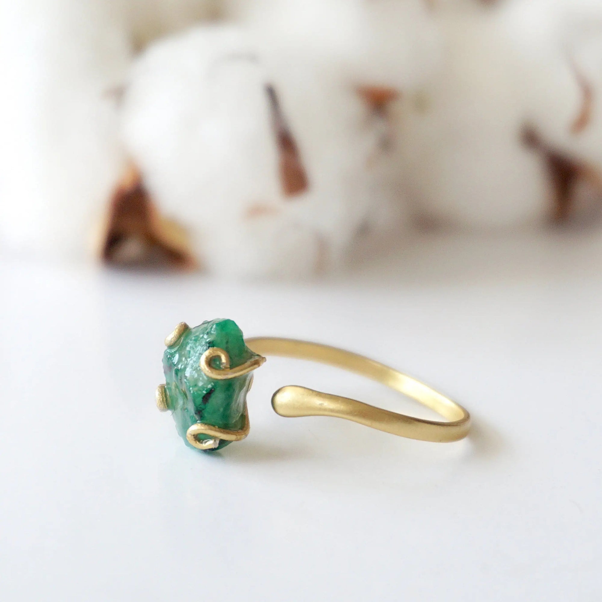 Right side detail of natural raw emerald ring in gold vermeil with adjustable artisan ring design