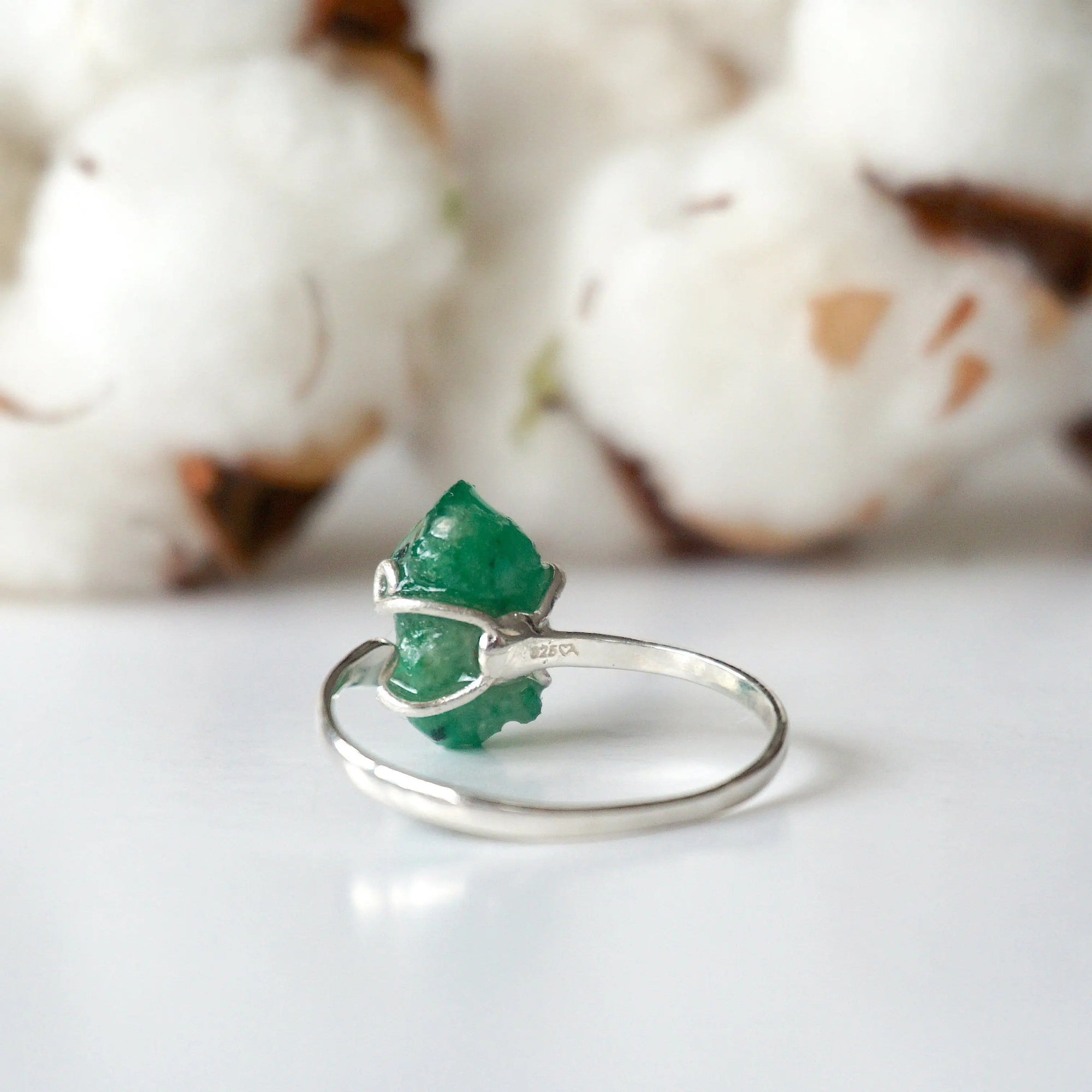 Back view of adjustable sterling silver emerald ring showing ring band and handcrafted setting details