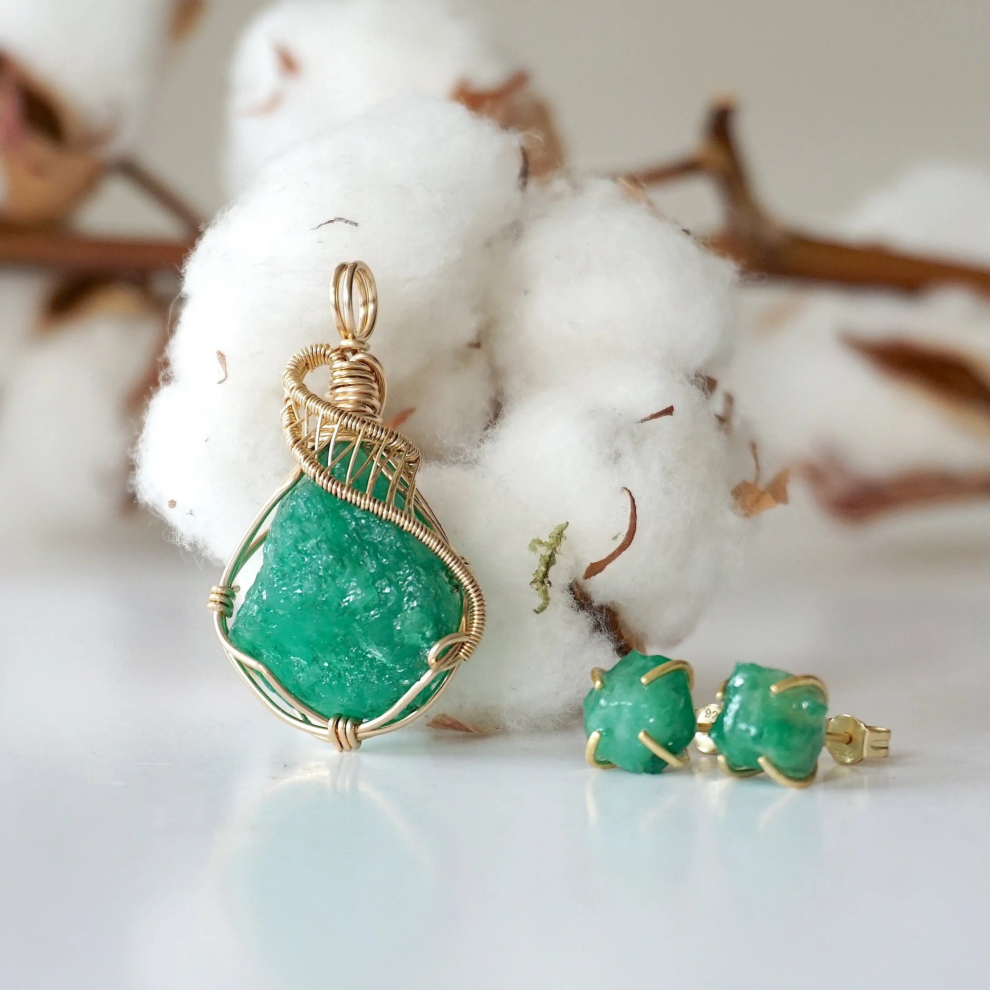 Detailed front view of raw emerald necklace pendant in 14k gold filled. Unique wire wrapped May birthstone necklace by Designs by Nature Gems.