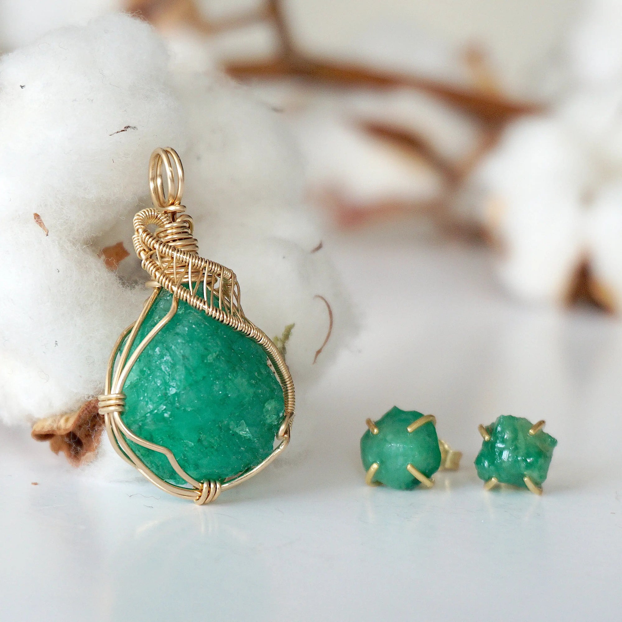 Right side view of raw emerald necklace pendant in 14k gold filled, showing artisan wire wrapping. Handcrafted May birthstone necklace by Designs by Nature Gems.