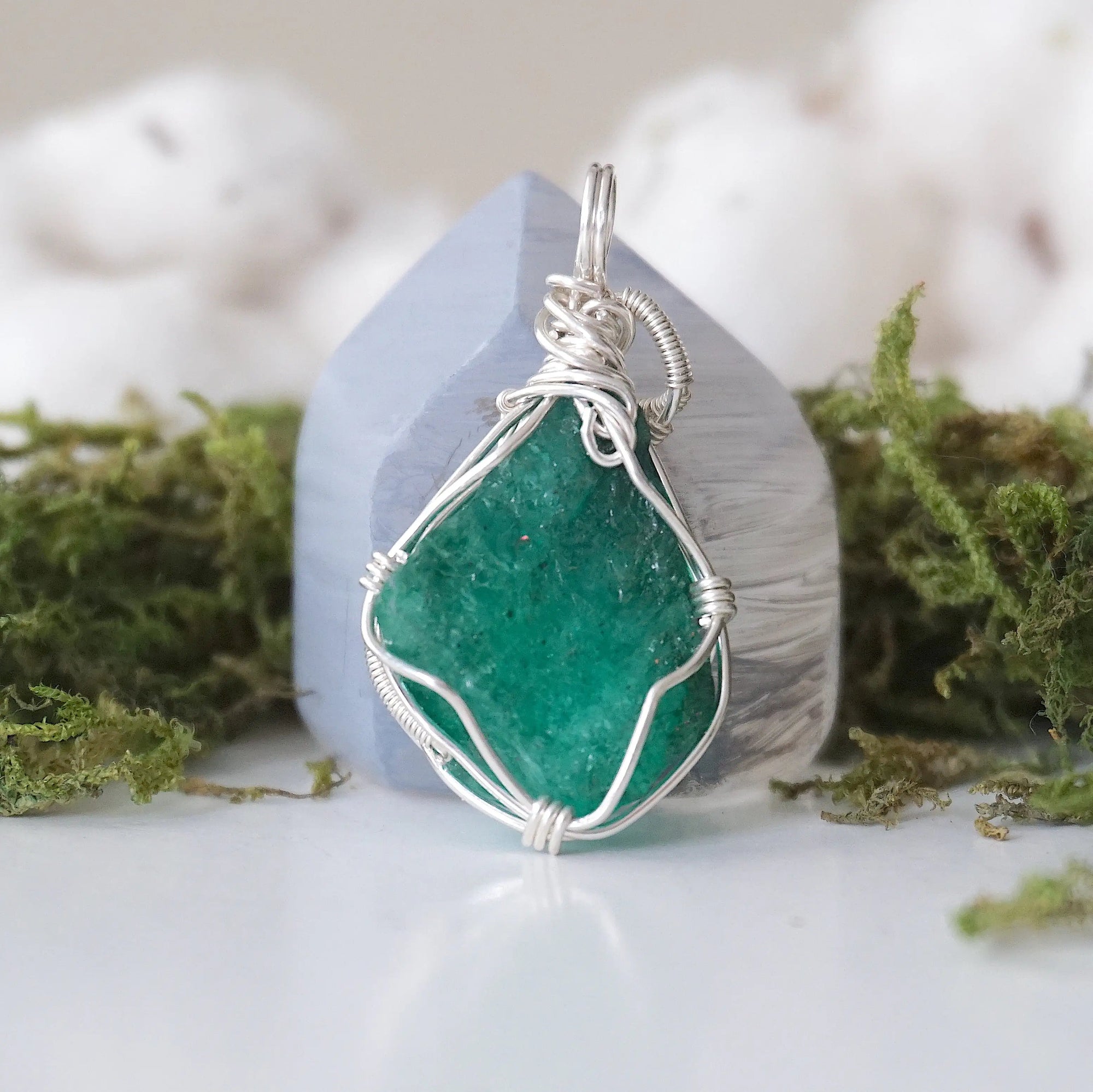 Back angle detail of raw emerald pendant necklace for women with natural emerald and handcrafted sterling silver wrapping