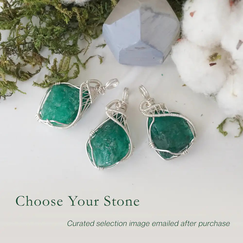 Three raw emerald pendants for women showing natural variation in emerald size, shape, and green colour in sterling silver wire wrapping