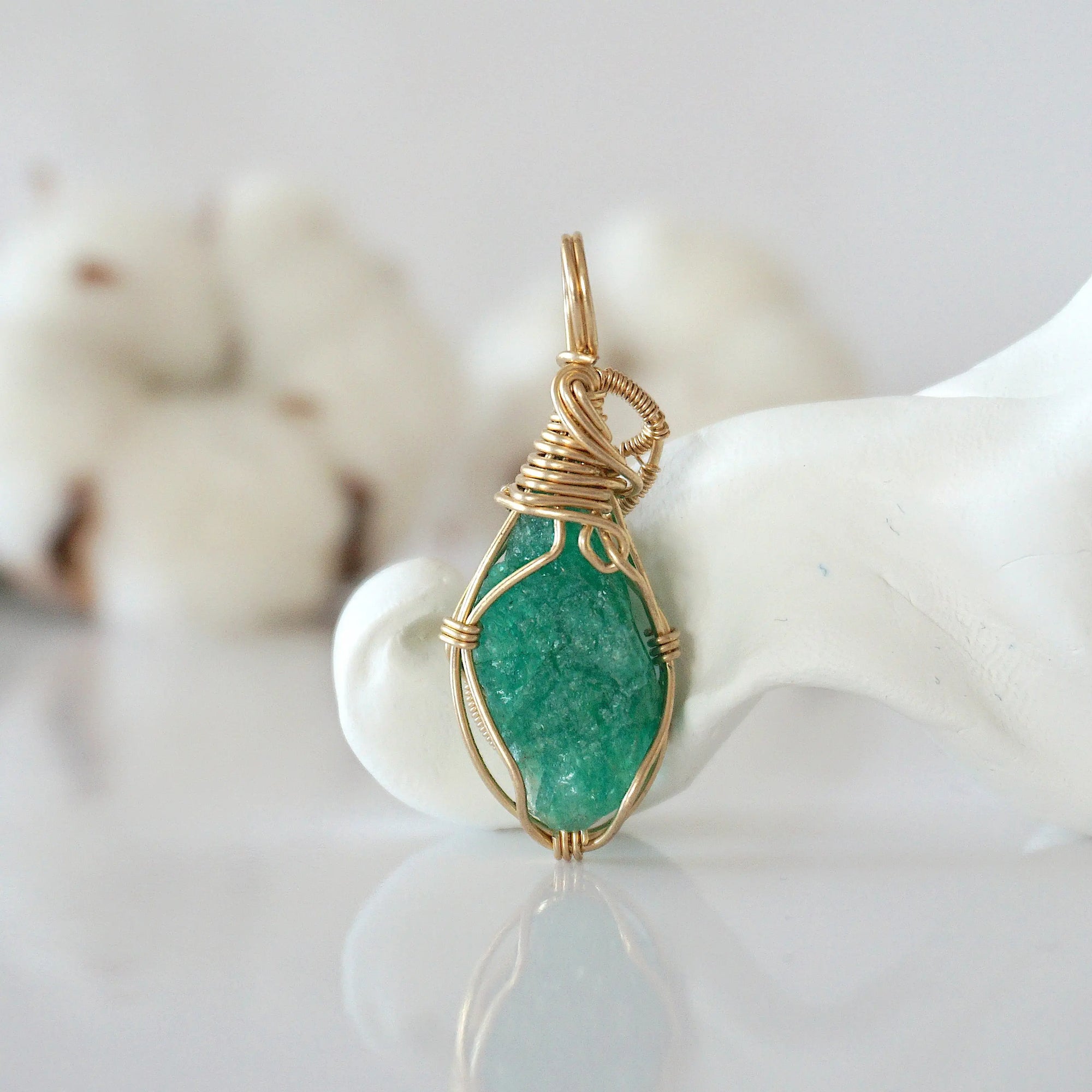 Back view of raw emerald pendant in 14k gold filled, highlighting stone and wire detail. One of a kind May birthstone jewelry by Designs by Nature Gems.
