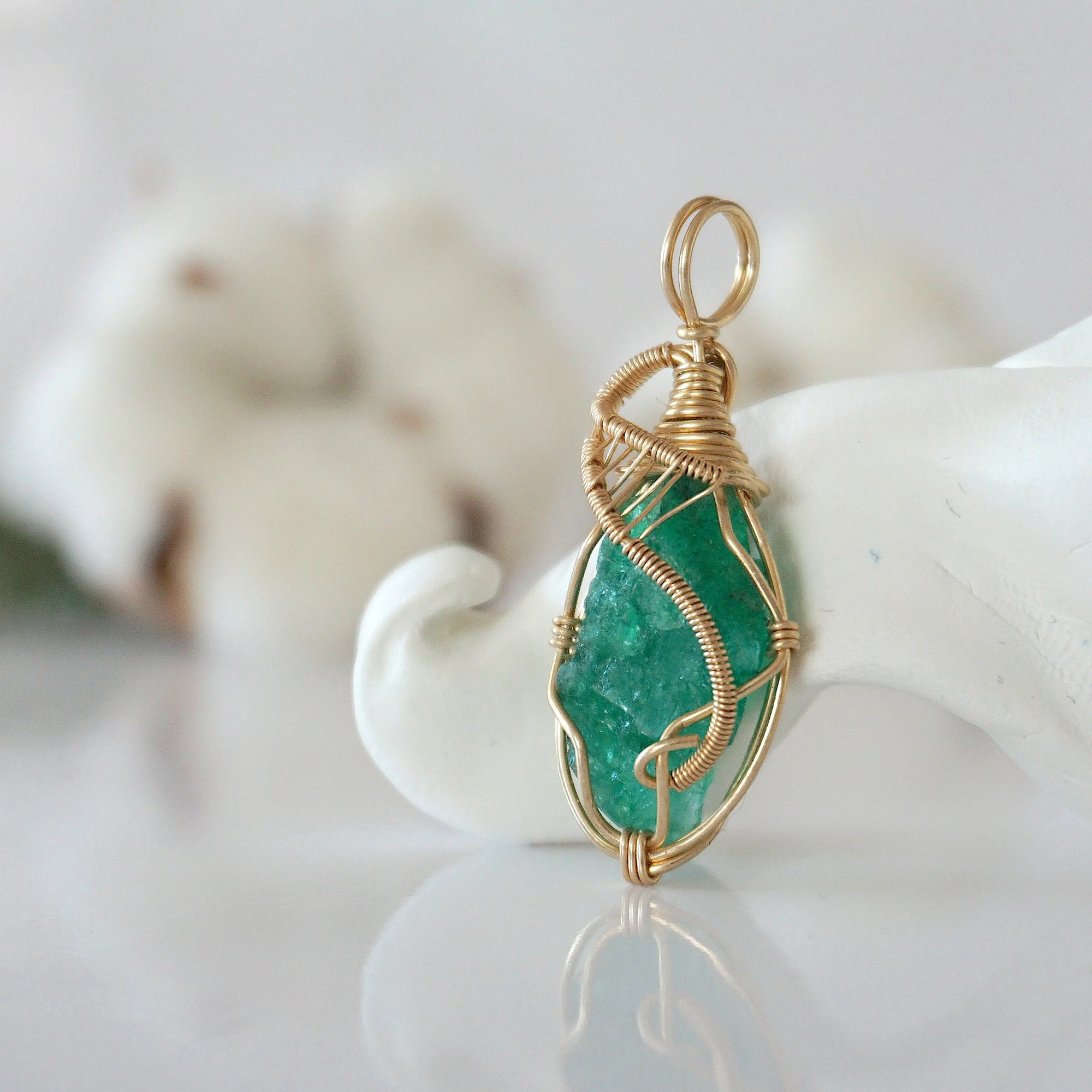 Side view of raw emerald pendant in 14k gold filled, showing artisan wire wrapping. Handcrafted May birthstone necklace by Designs by Nature Gems.